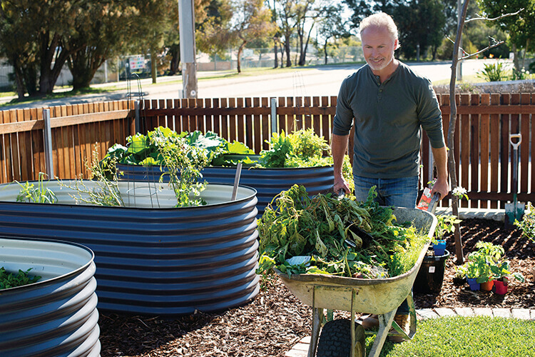 Man in the garden with a wheelbarrow