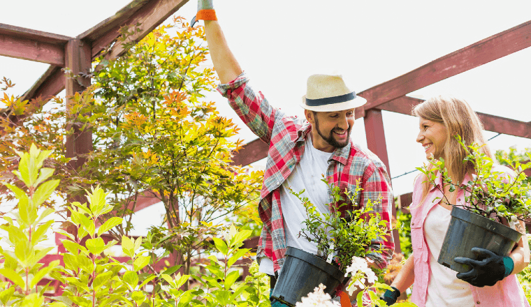 Young couple at a garden centre selecting plants and trees